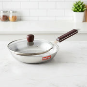 Max Fresh stainless steel frying pan with glass lid and wooden handle on white kitchen counter
